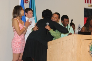 Dahian Rodriguez hugs Summer Bridge English Instructor Tanya Morehead-Cooley during the graduation ceremony.