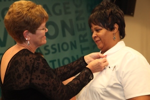 Nursing Program Director Jan Costello pins Jamie Mattos during a ceremony held in December. Mattos, who is now seeking her RN-to-BSN at Goodwin, has become one the of College's most active student poets.